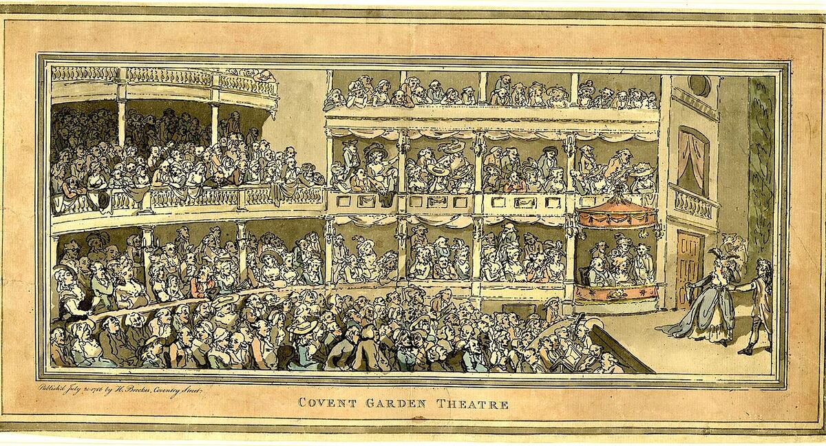 A coloured print of a crowded theatre, boxes and pit full, with the prompter at the corner of the stage